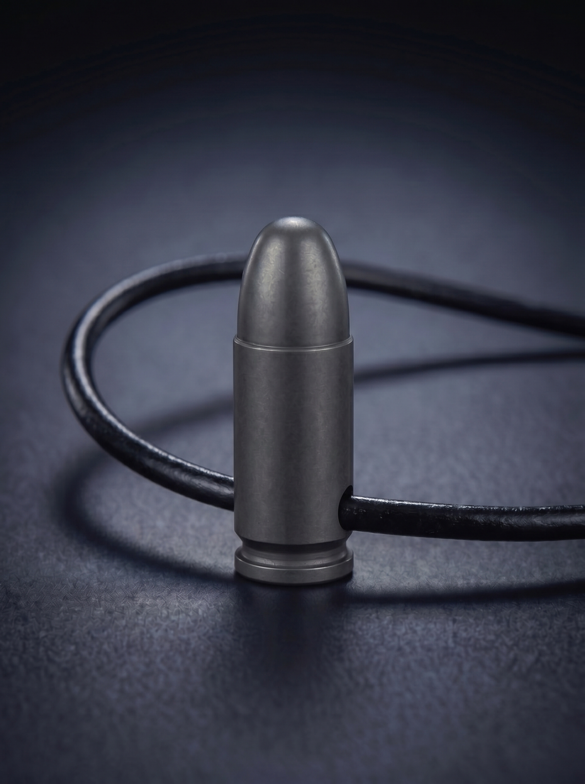 Black titanium pistol cartridge pendant on black leather cord