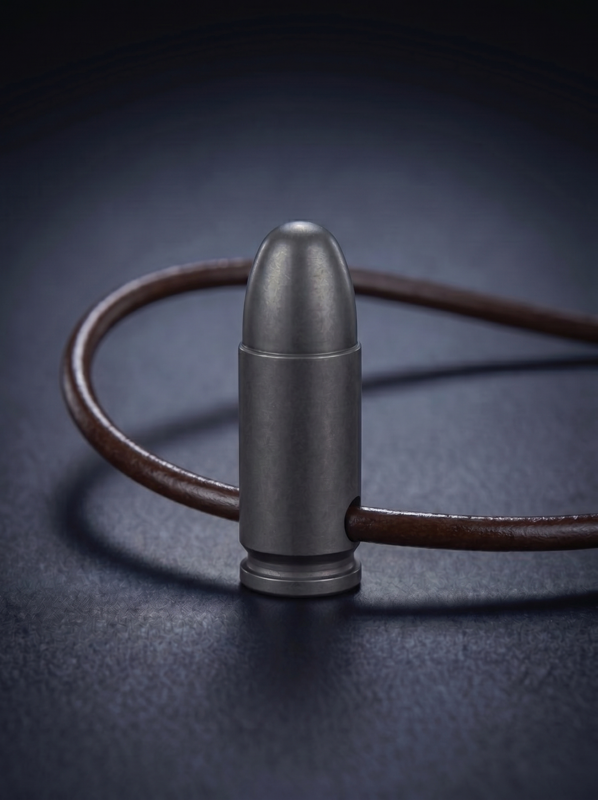 Black titanium pistol cartridge pendant on brown leather cord