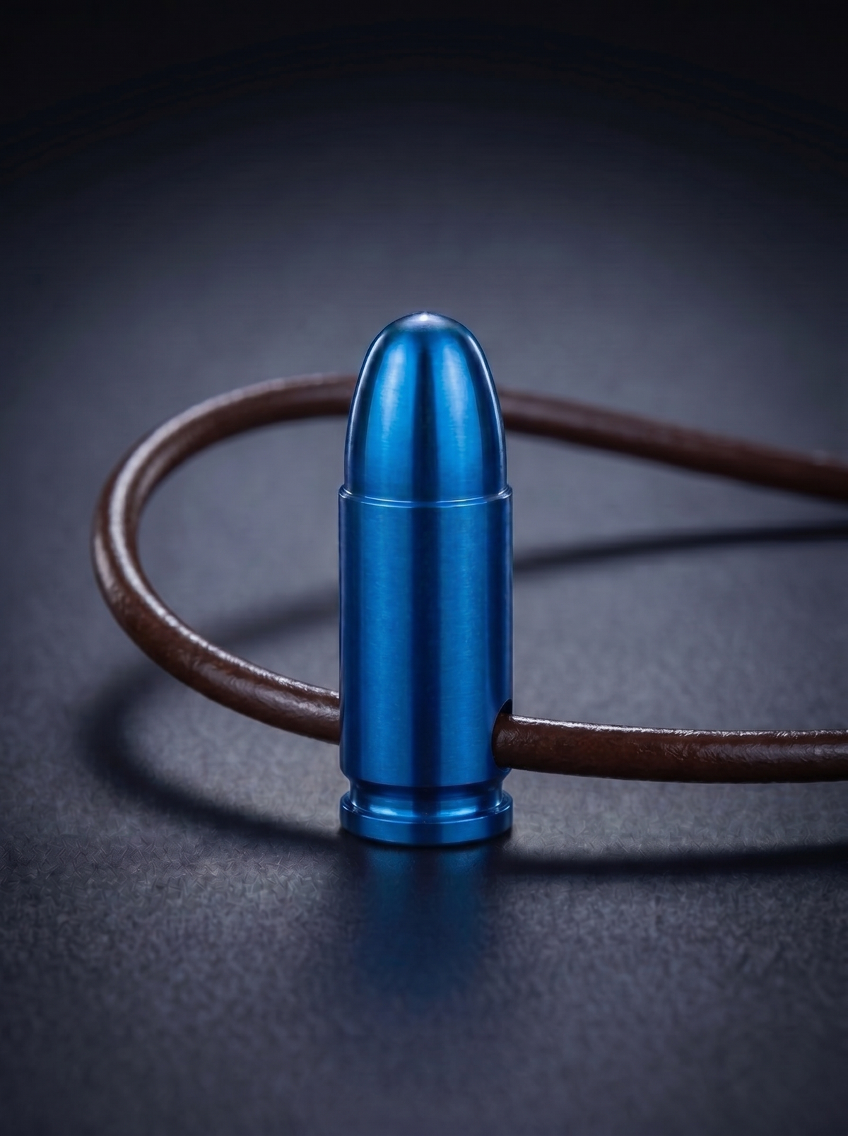 Blue titanium pistol cartridge pendant on brown leather cord