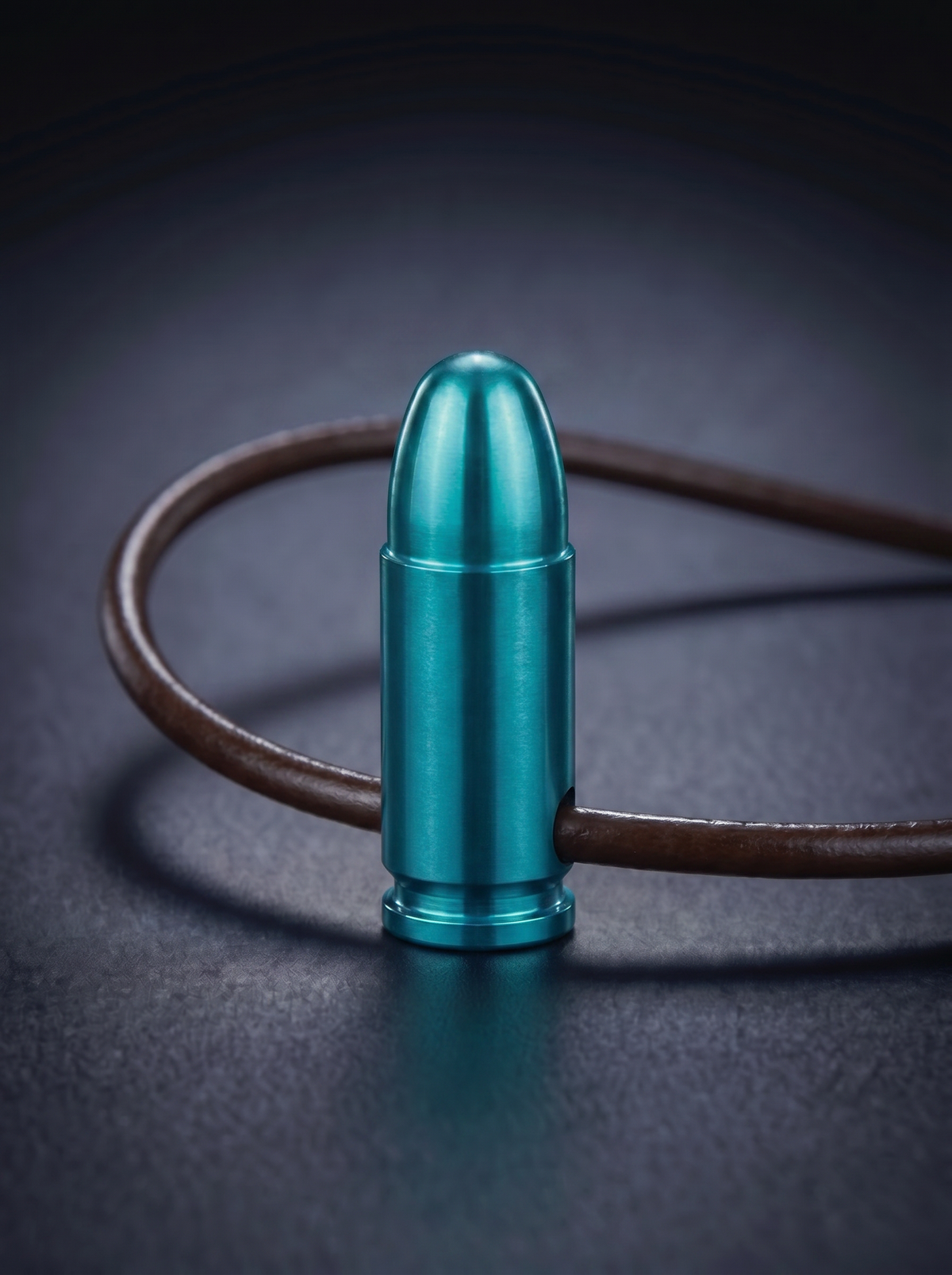 Green titanium pistol cartridge pendant on brown leather cord