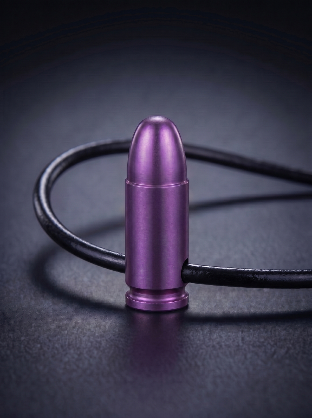 Magenta titanium pistol cartridge pendant on black leather cord
