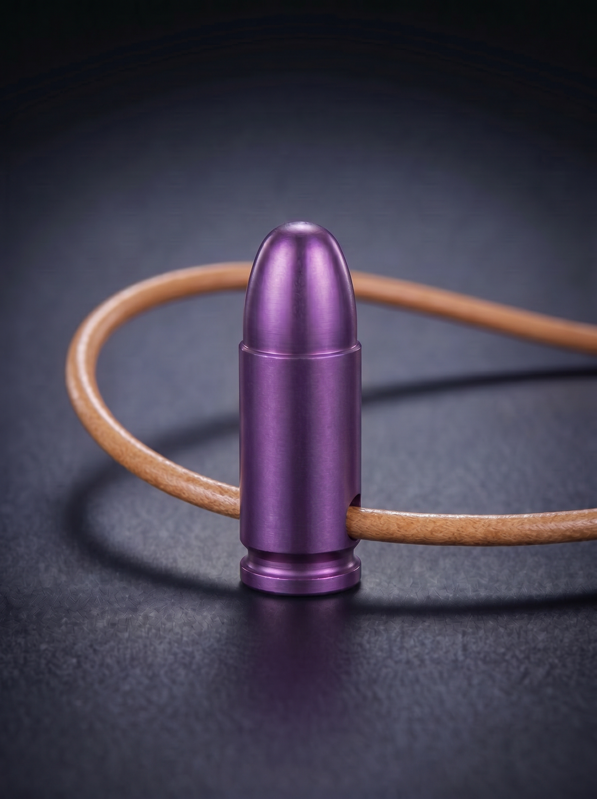 Magenta titanium pistol cartridge pendant on original leather cord