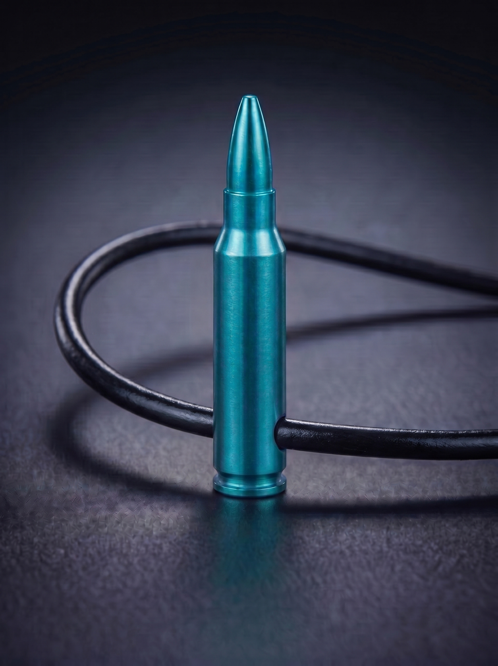 Green titanium rifle cartridge pendant on black leather cord