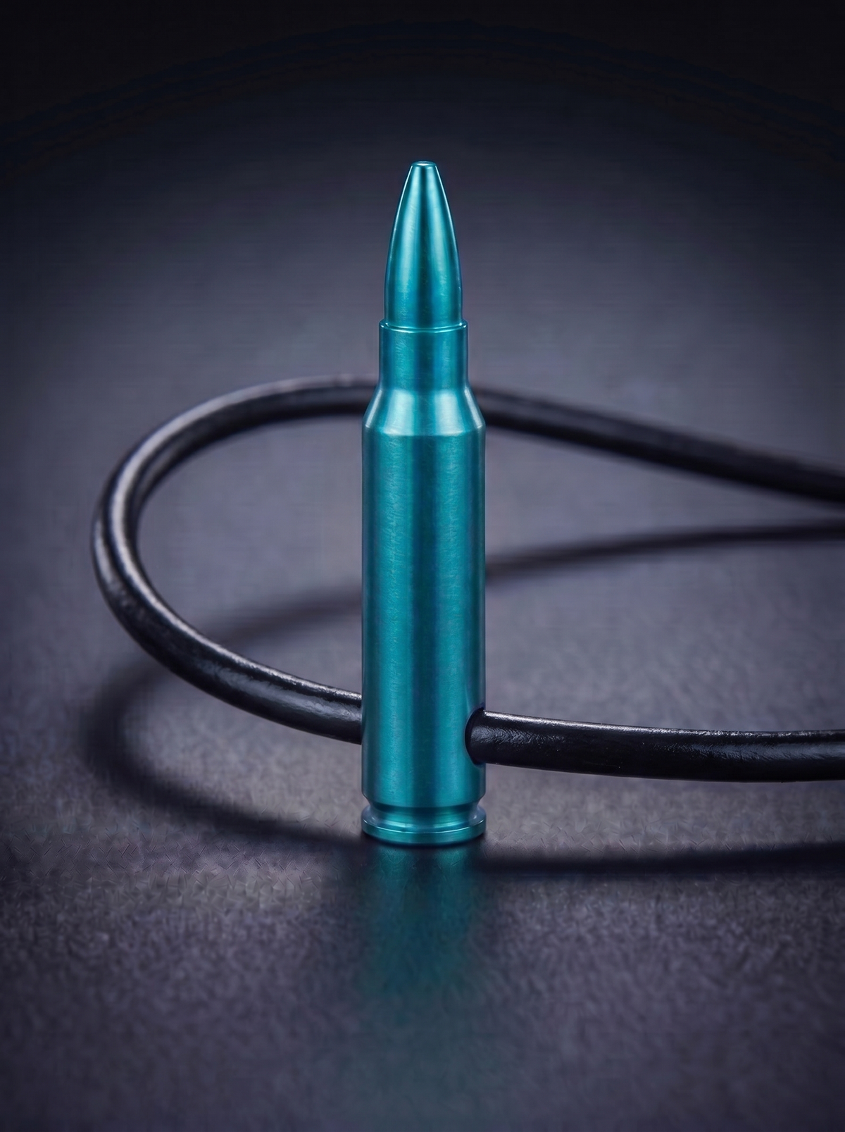 Green titanium rifle cartridge pendant on black leather cord