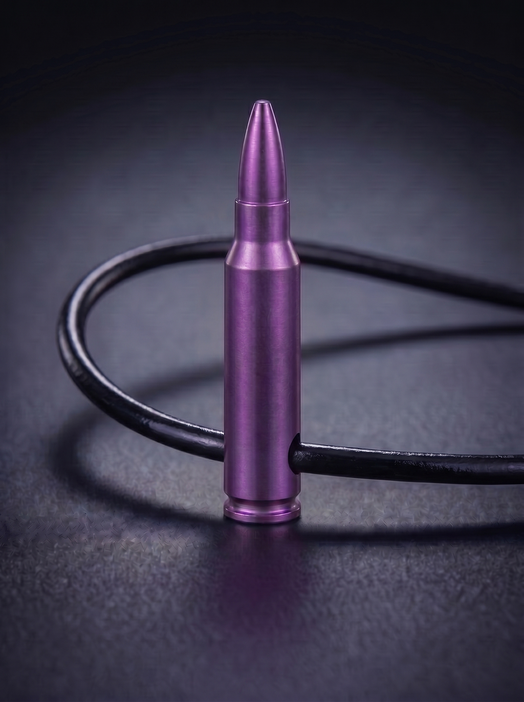 Magenta titanium rifle cartridge pendant on black leather cord