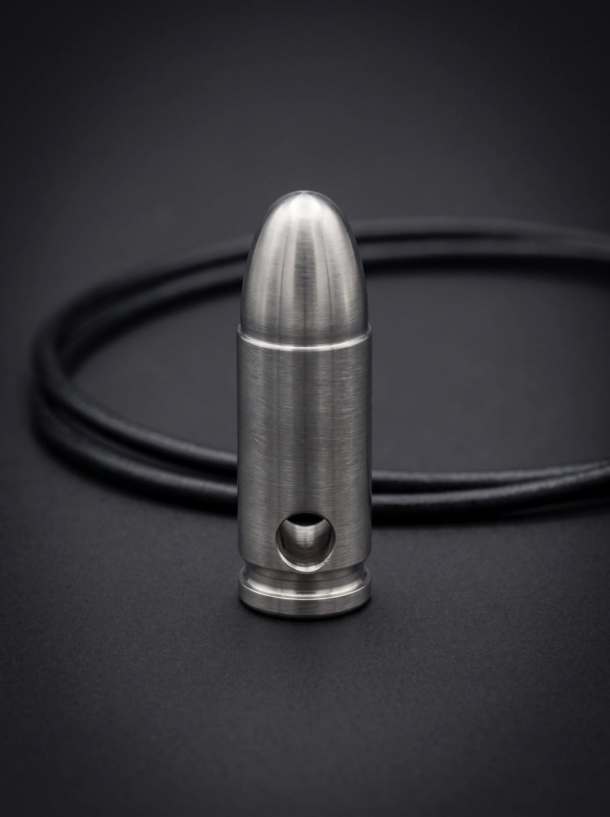Natural titanium pistol cartridge pendant on black leather cord