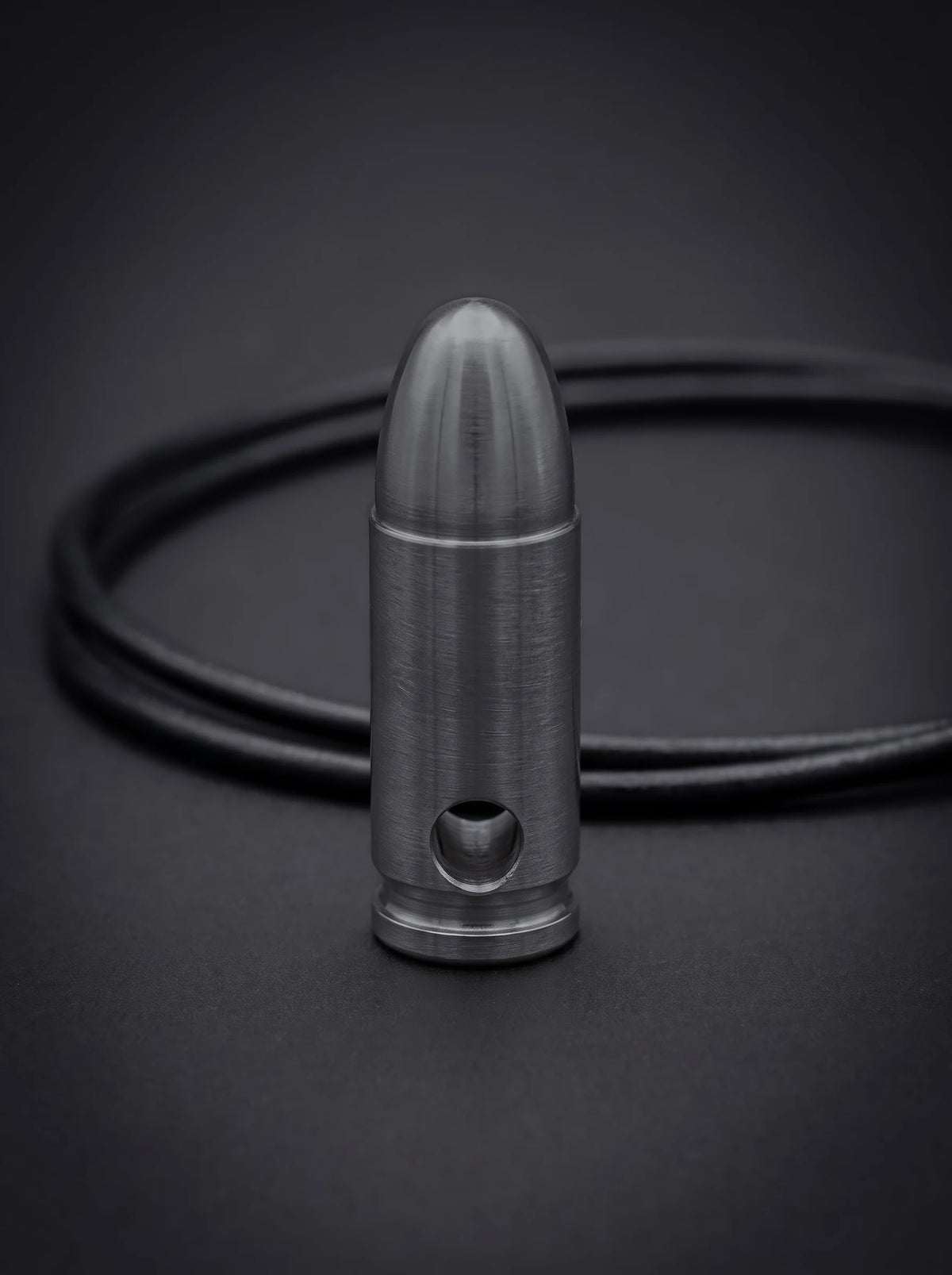 Black titanium pistol cartridge pendant on black leather cord