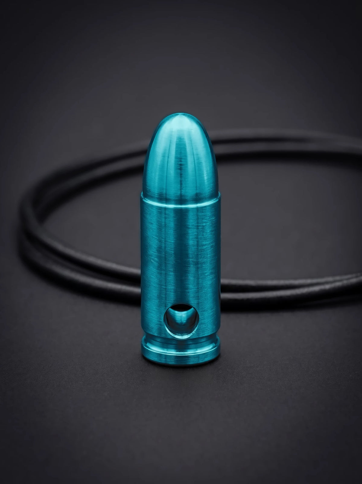 Green titanium pistol cartridge pendant on black leather cord