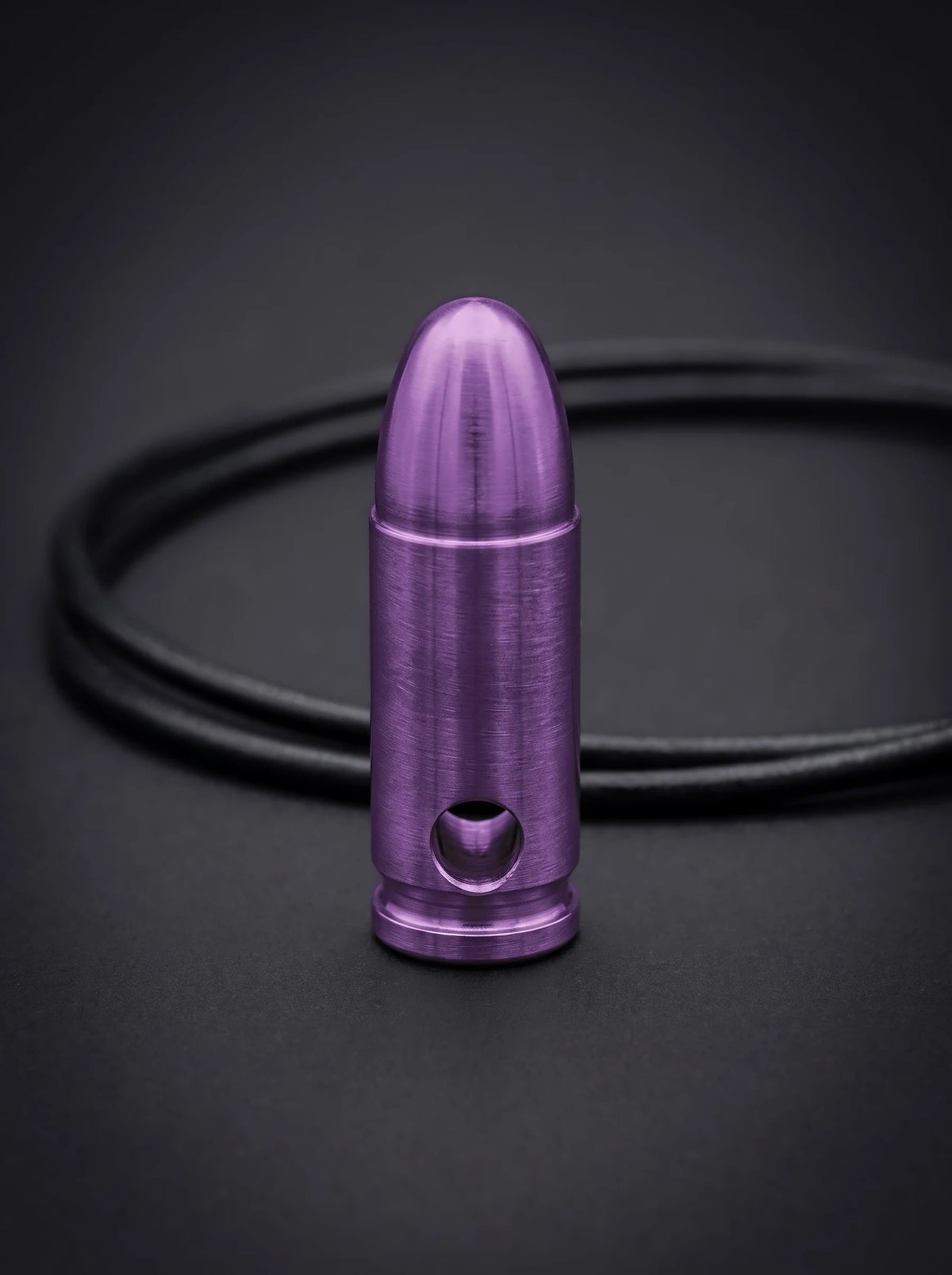 Magenta titanium pistol cartridge pendant on black leather cord