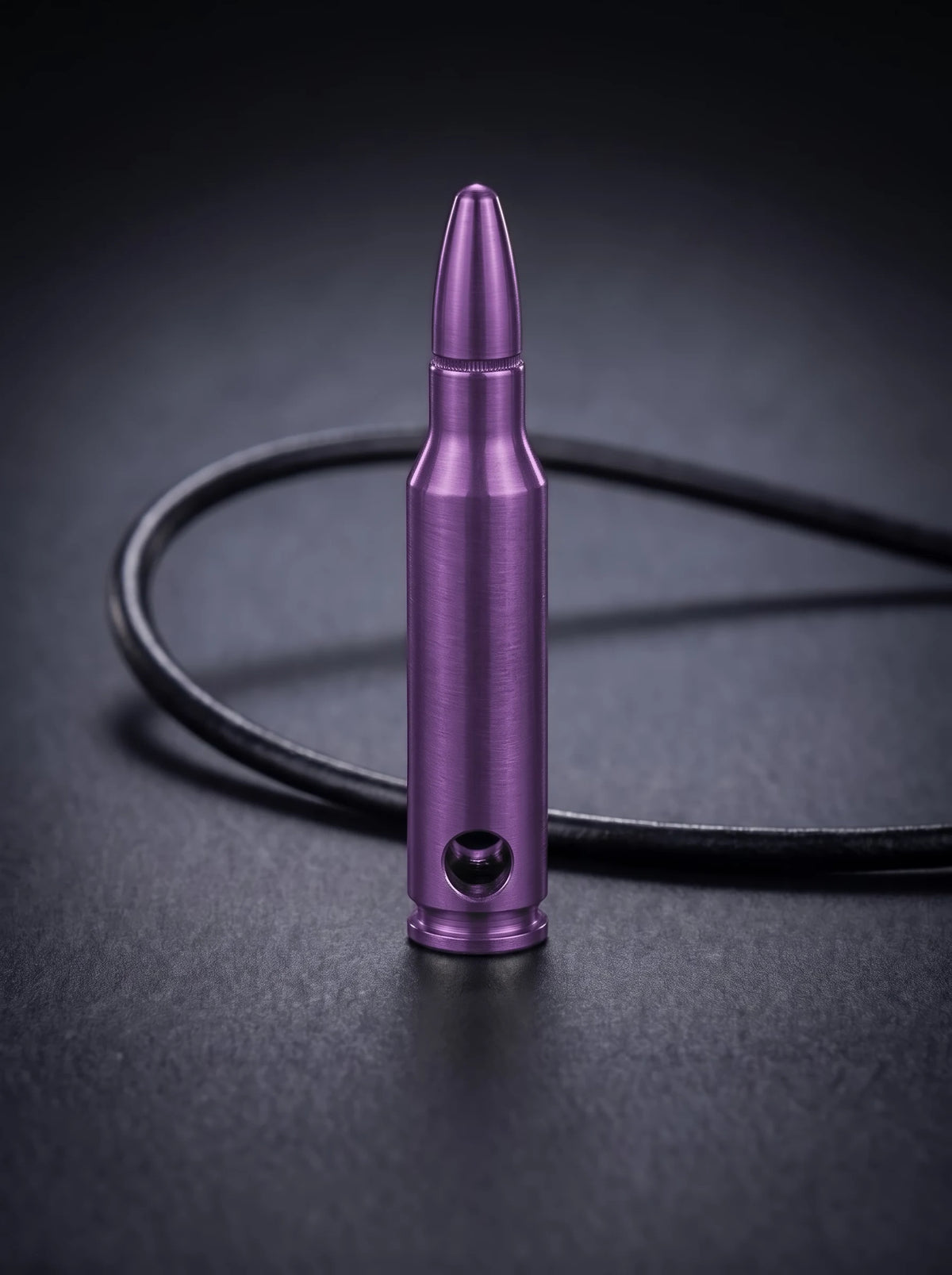 Magenta titanium rifle cartridge pendant on black leather cord